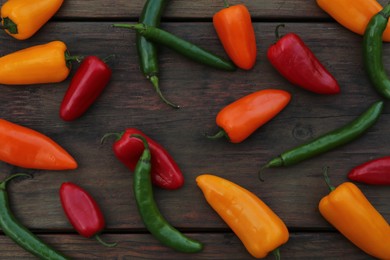 Different ripe bell peppers on wooden table, flat lay