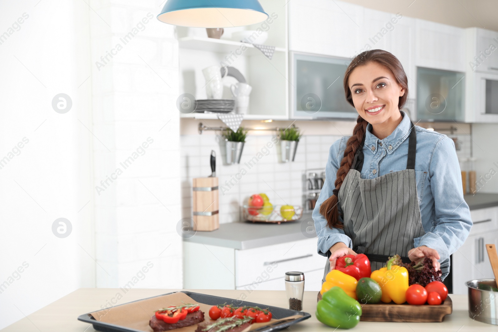 Photo of Professional female chef standing near table in kitchen