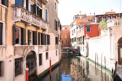 VENICE, ITALY - JUNE 13, 2019: City canal with old buildings and boats