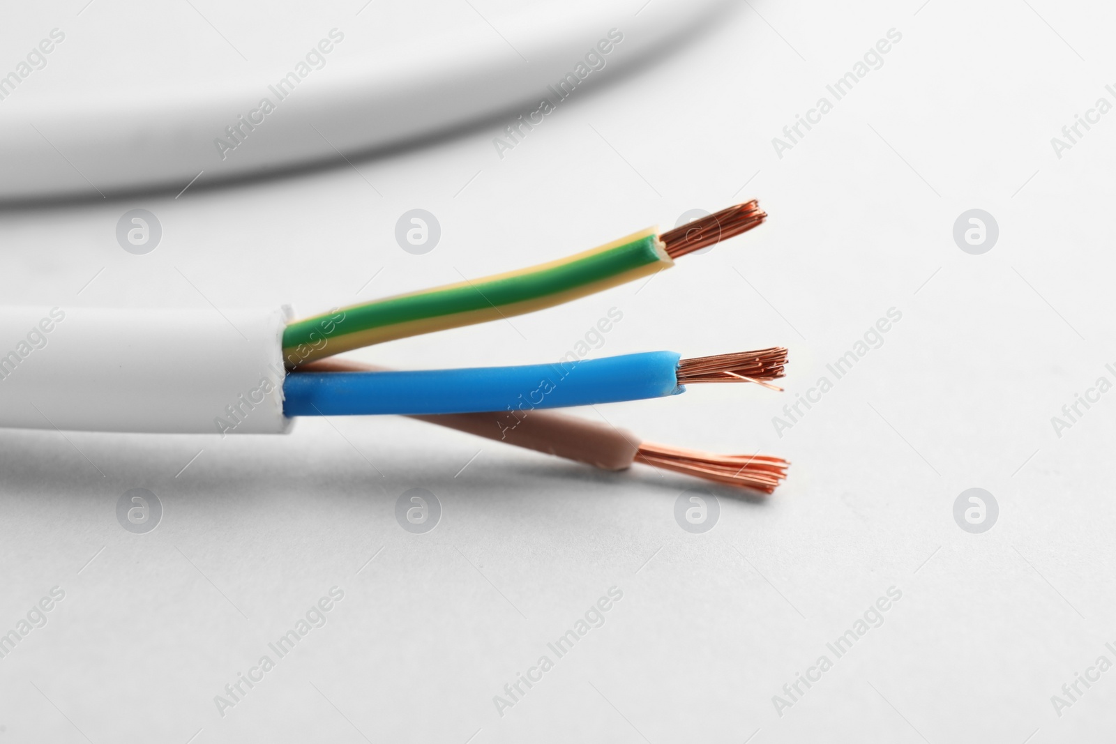 Photo of Closeup view of electrical power cables on white background