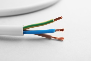 Closeup view of electrical power cables on white background