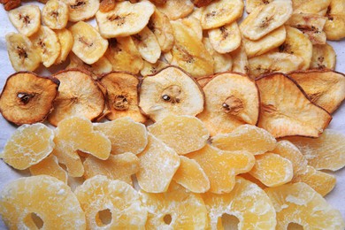 Photo of Different tasty dried fruits as background, top view