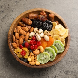 Photo of Plate with different dried fruits and nuts on table, top view