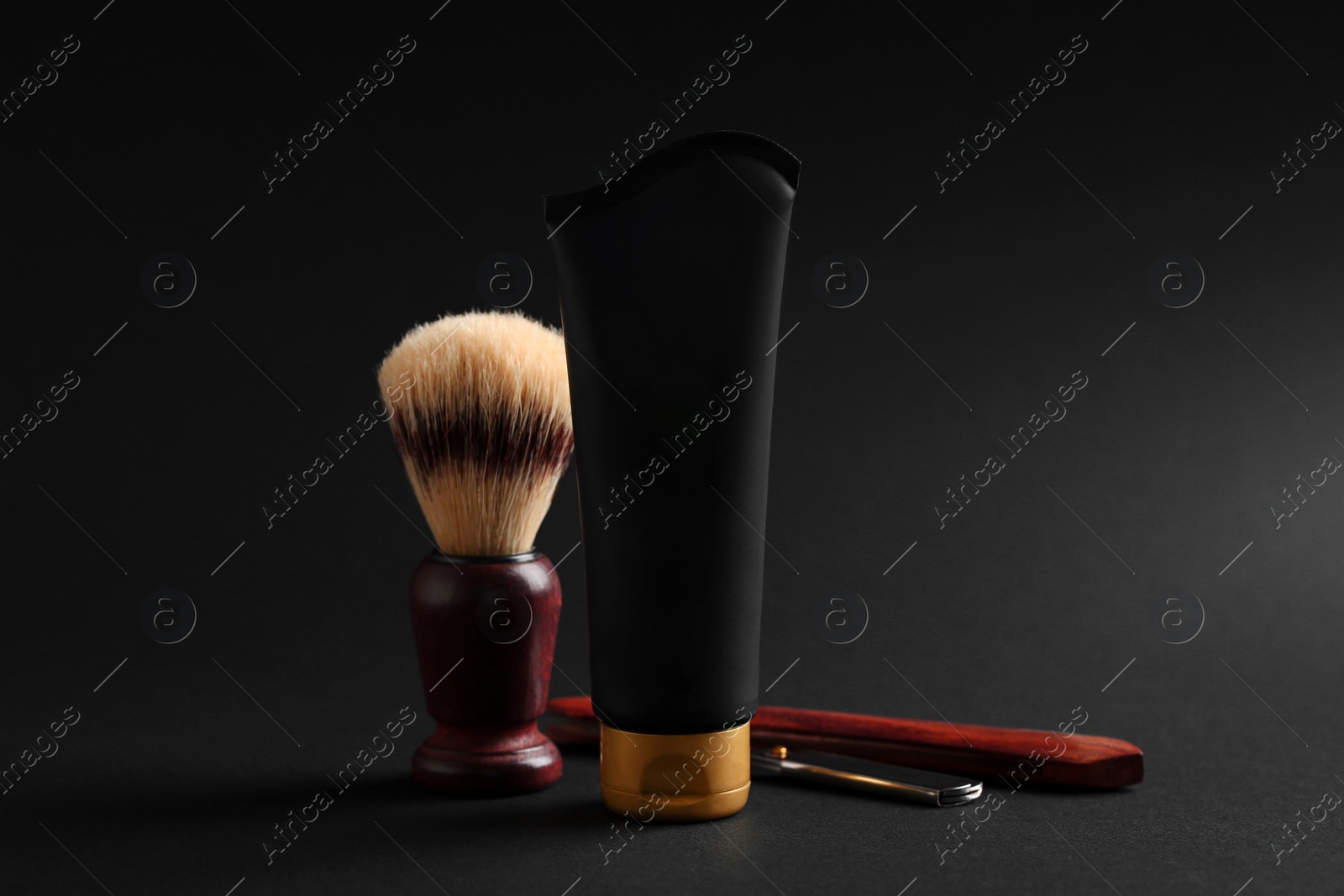 Photo of Set of shaving equipment and men's cosmetic product on black background