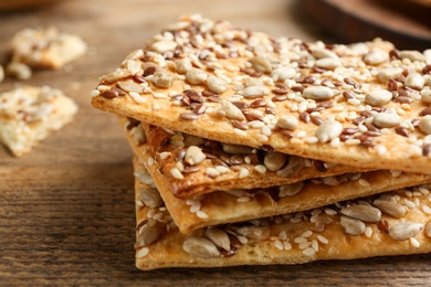 Photo of Stack of delicious crackers on table, closeup