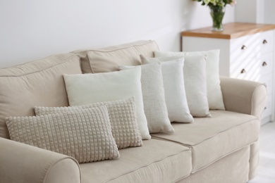 Photo of Sofa with pillows in modern living room interior