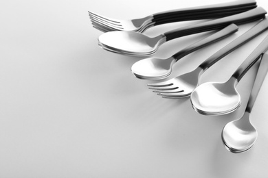 Photo of Forks and spoons on white background. New cutlery