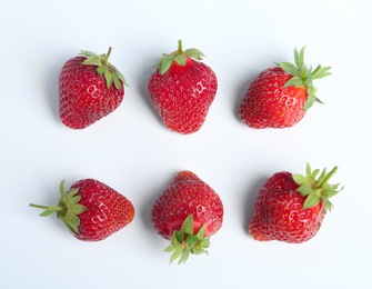 Photo of Tasty ripe strawberries on white background, flat lay