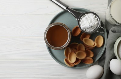 Photo of Ingredients for delicious walnut shaped cookies with condensed milk on white wooden table, flat lay. Space for text