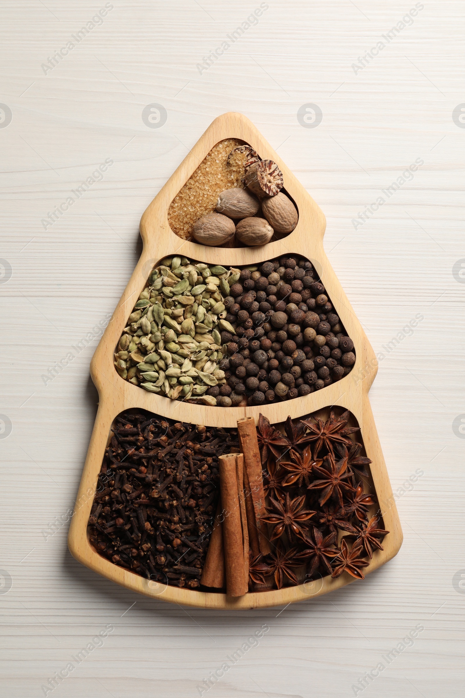 Photo of Different spices and nuts on white wooden table, top view