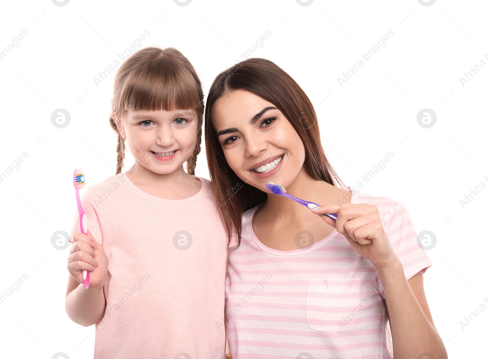 Photo of Little girl and her mother brushing teeth together on white background