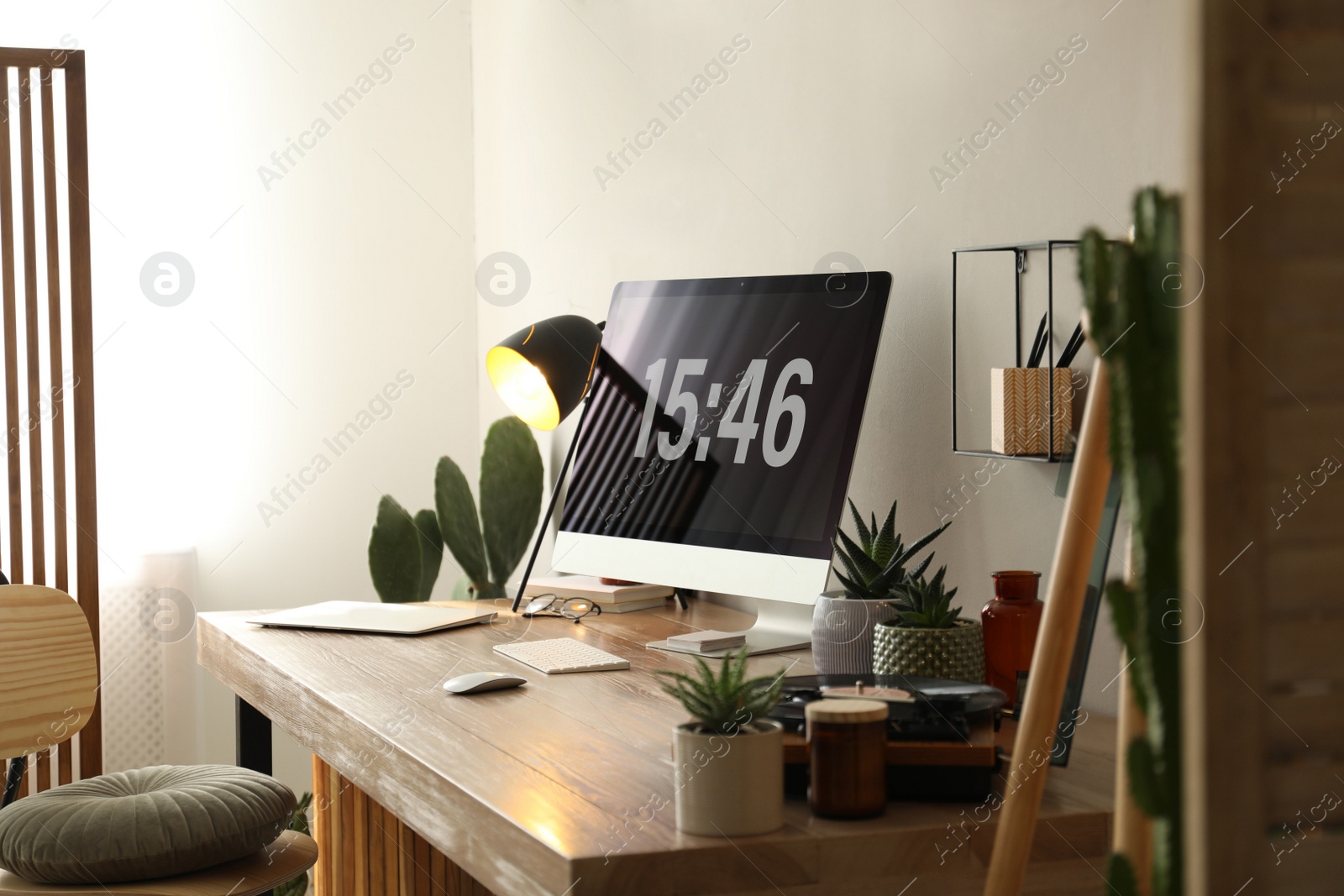 Photo of Modern computer and laptop on wooden desk in room. Interior design