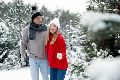 Photo of Beautiful happy couple in snowy forest on winter day