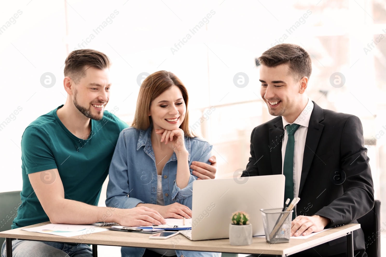 Photo of Young couple meeting with consultant in office