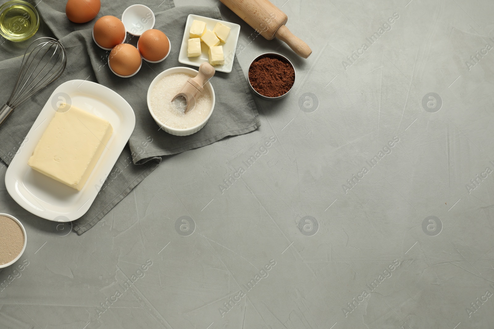 Photo of Flat lay composition with fresh butter and other products on grey table. Space for text