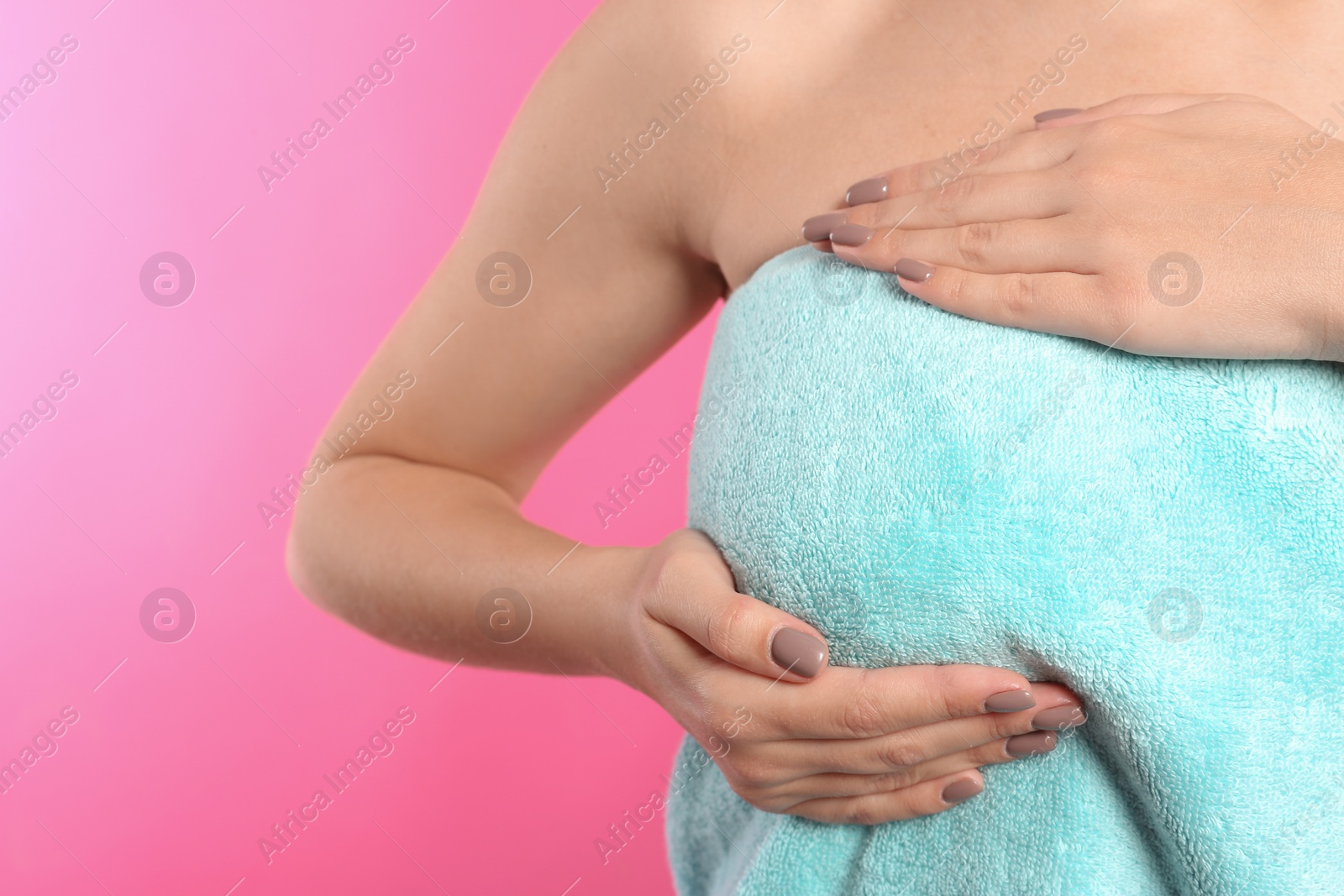 Photo of Woman checking her breast on color background, closeup