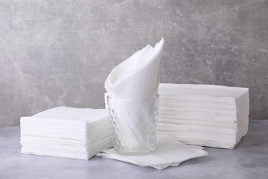 Photo of Clean paper towels and tissues on grey table