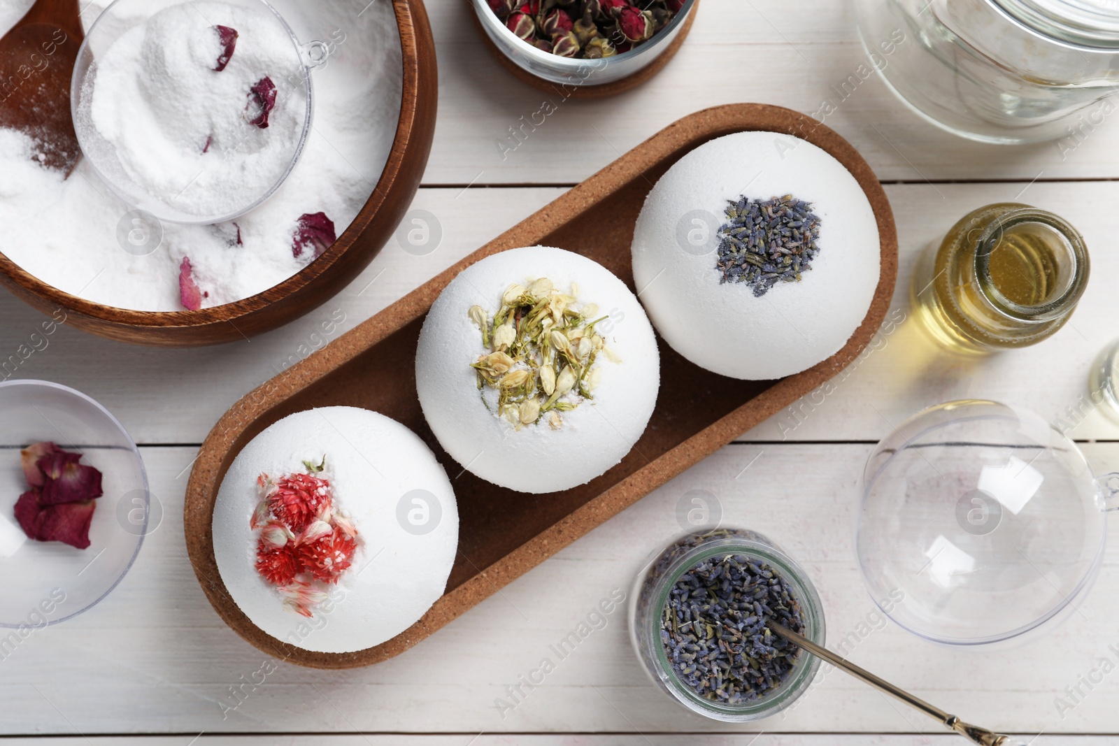 Photo of Flat lay composition with bath bombs and ingredients on white wooden table