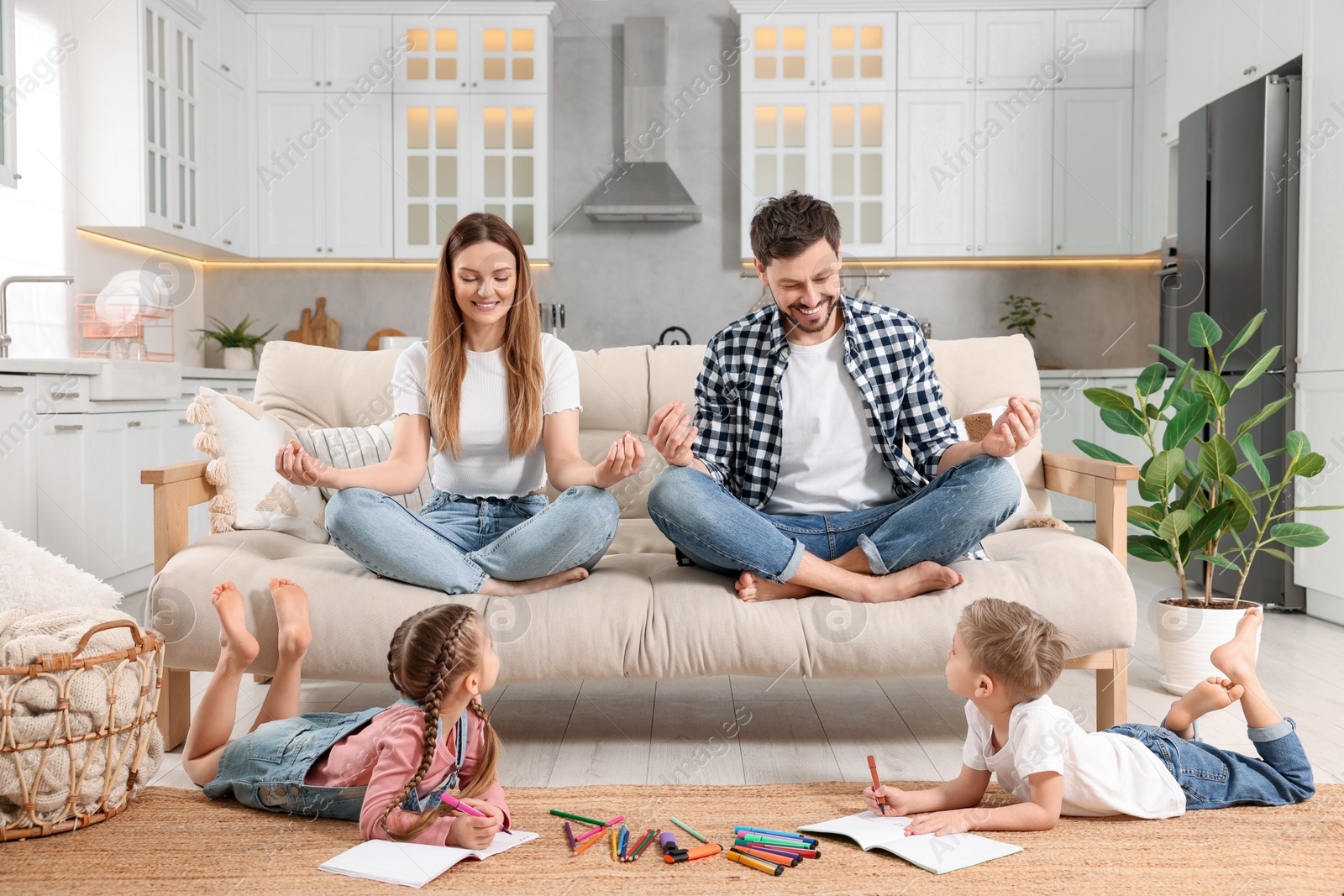 Photo of Parents meditating while their children painting at home