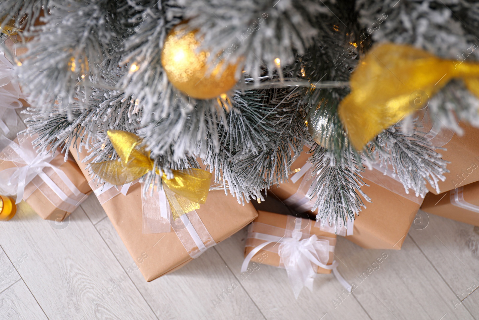 Photo of Decorated Christmas tree and gift boxes indoors, top view. Stylish interior element