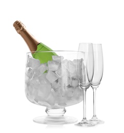 Photo of Bottle of champagne in vase with ice and flutes on white background