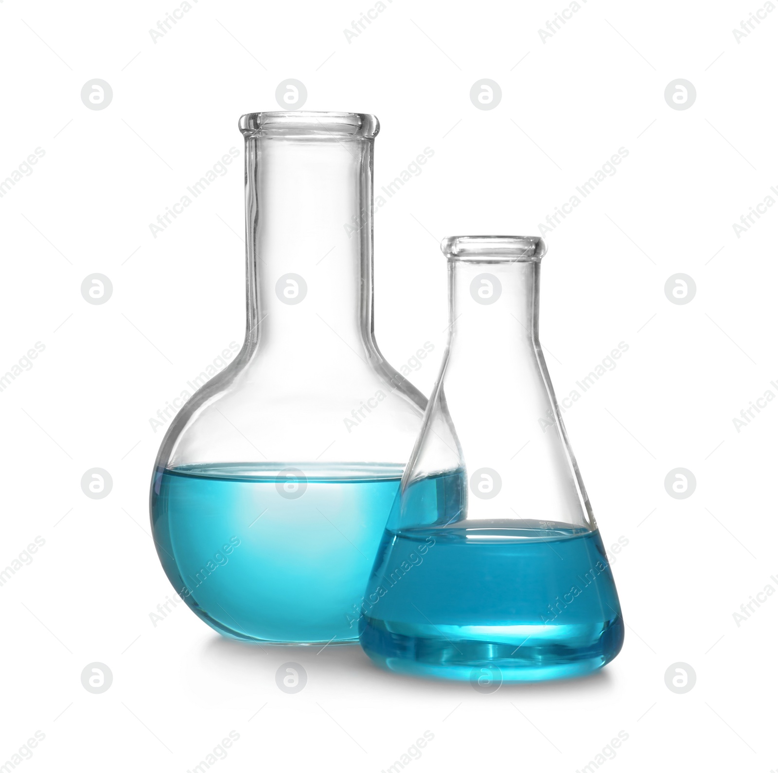 Photo of Laboratory glassware with liquid on white background. Solution chemistry