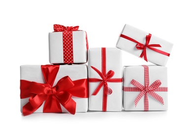 Photo of Beautifully wrapped gift boxes on white background