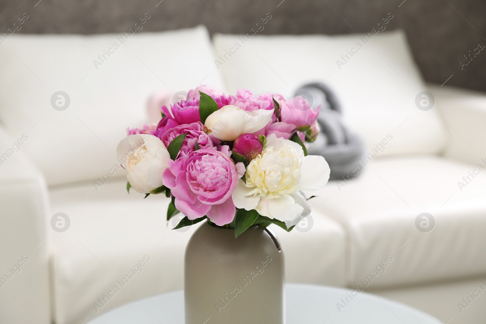 Photo of Vase with bouquet of beautiful peonies in room