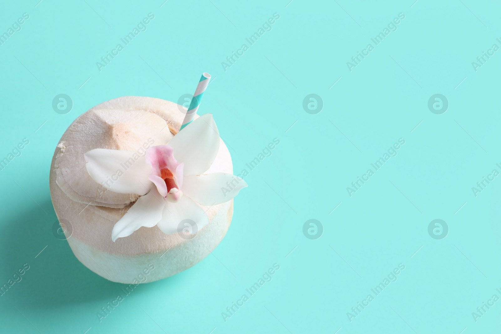 Photo of Fresh coconut drink in nut on color background