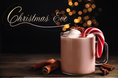 Image of Christmas Eve, postcard design. Glass cup of tasty cocoa with marshmallows and candy cane on wooden table against blurred festive lights
