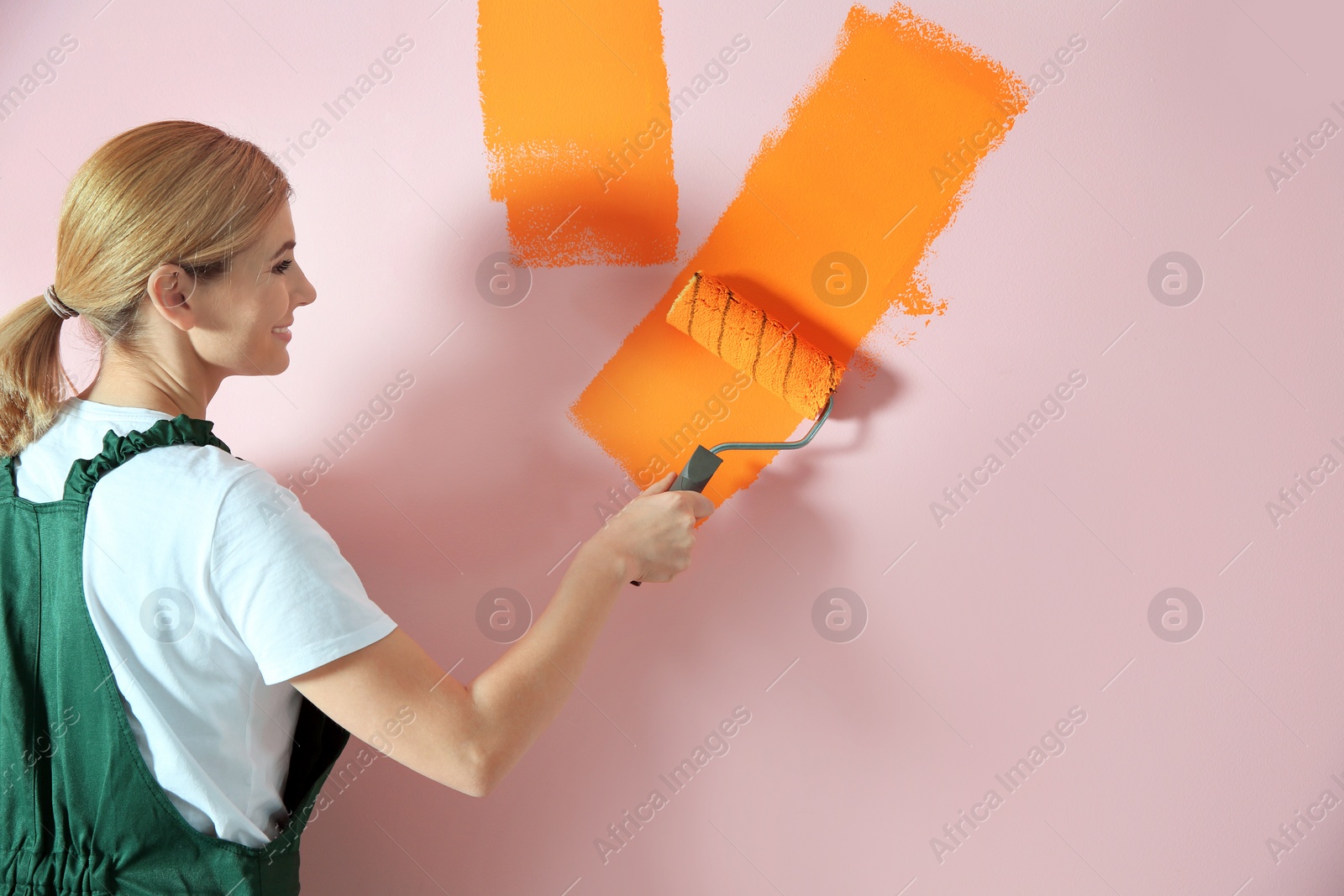 Photo of Professional decorator painting wall, space for text. Home repair service