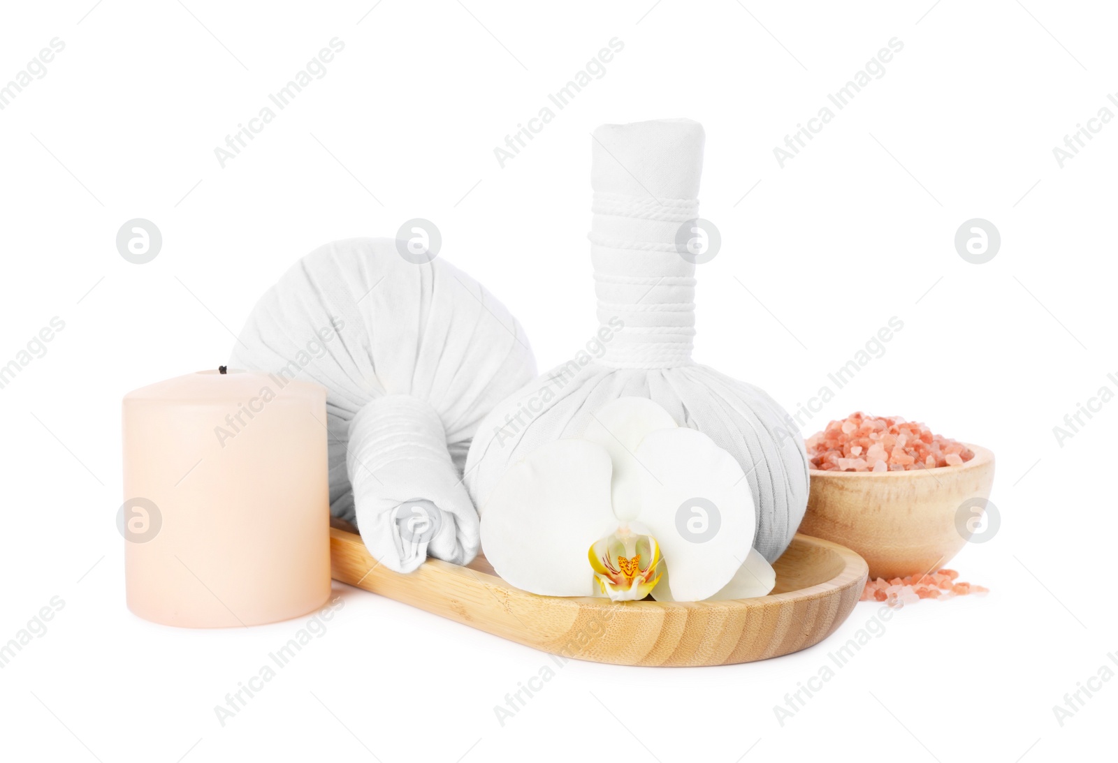 Photo of Wooden tray with herbal massage bags and different spa products on white background