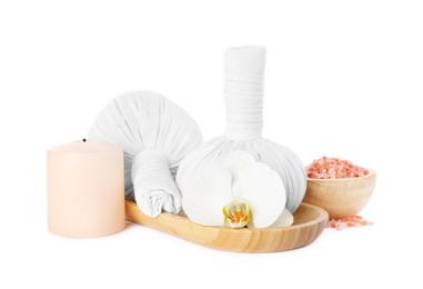 Photo of Wooden tray with herbal massage bags and different spa products on white background