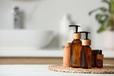 Photo of Different personal care products on white wooden table in bathroom. Space for text