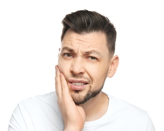 Photo of Young man suffering from toothache on white background