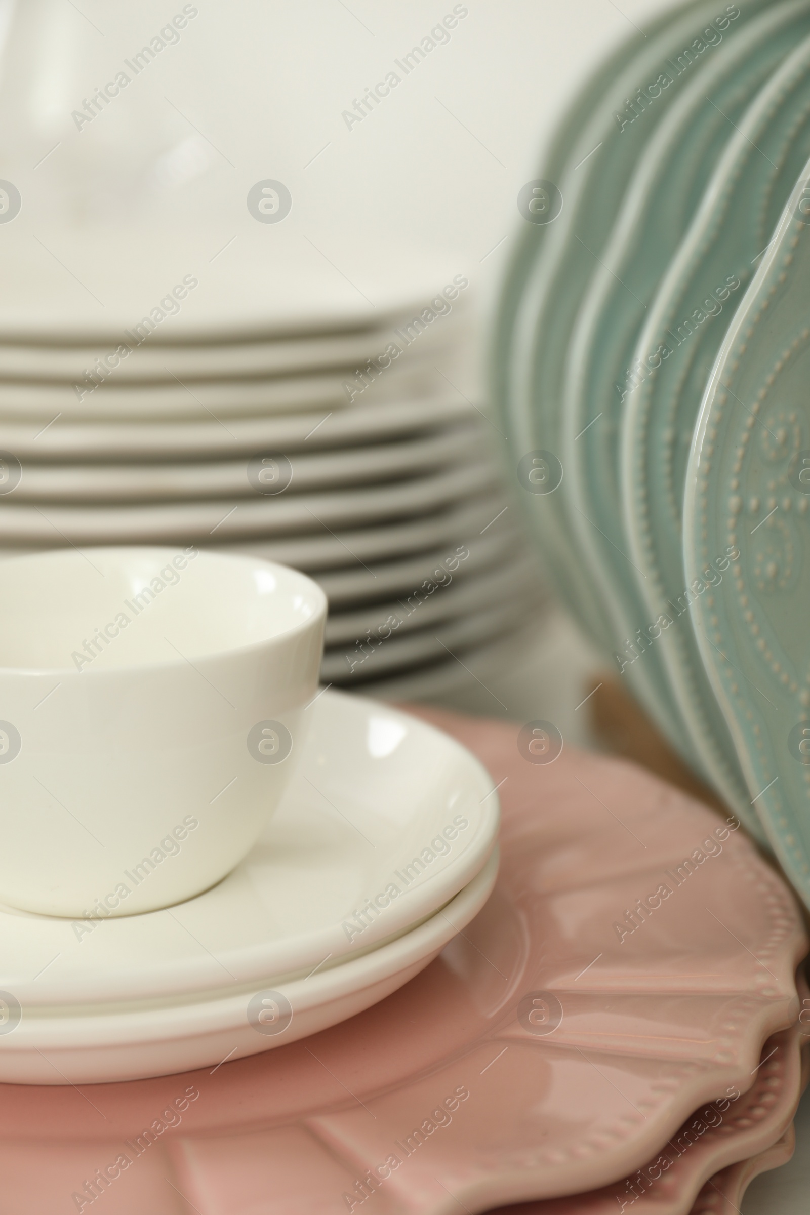 Photo of Clean plates and cup on table, closeup