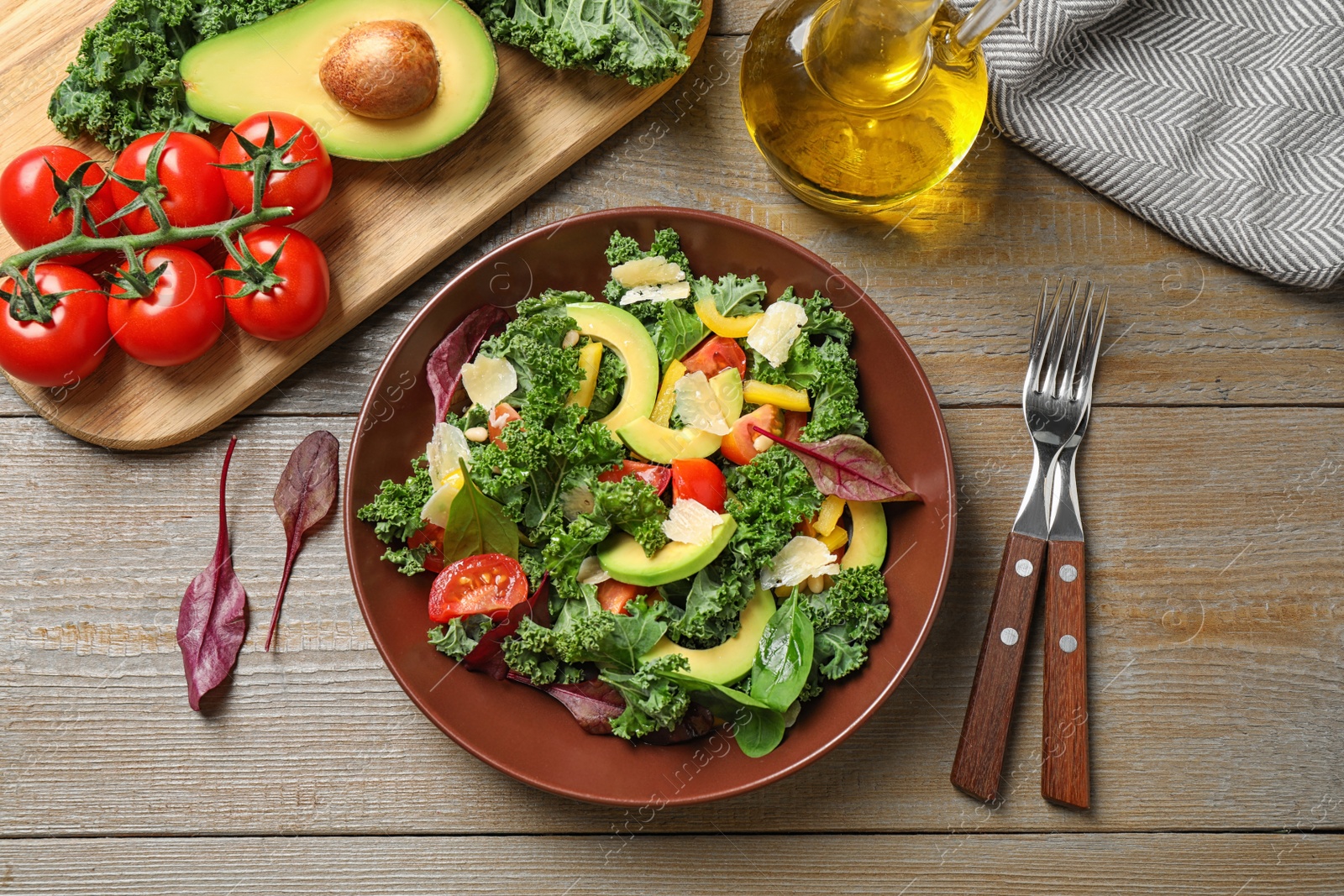 Photo of Tasty fresh kale salad on wooden table, flat lay