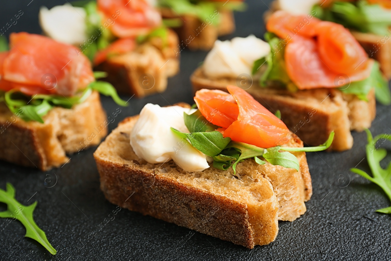 Photo of Tasty sandwiches with fresh sliced salmon fillet on table