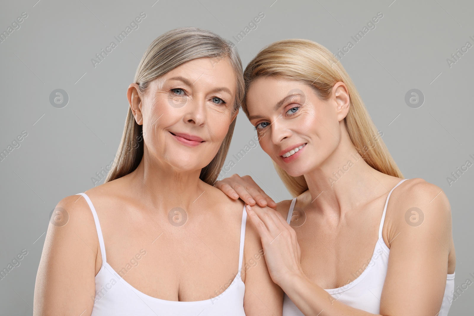 Photo of Beautiful women with healthy skin on gray background