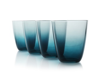 Photo of Empty elegant colorful glasses on white background