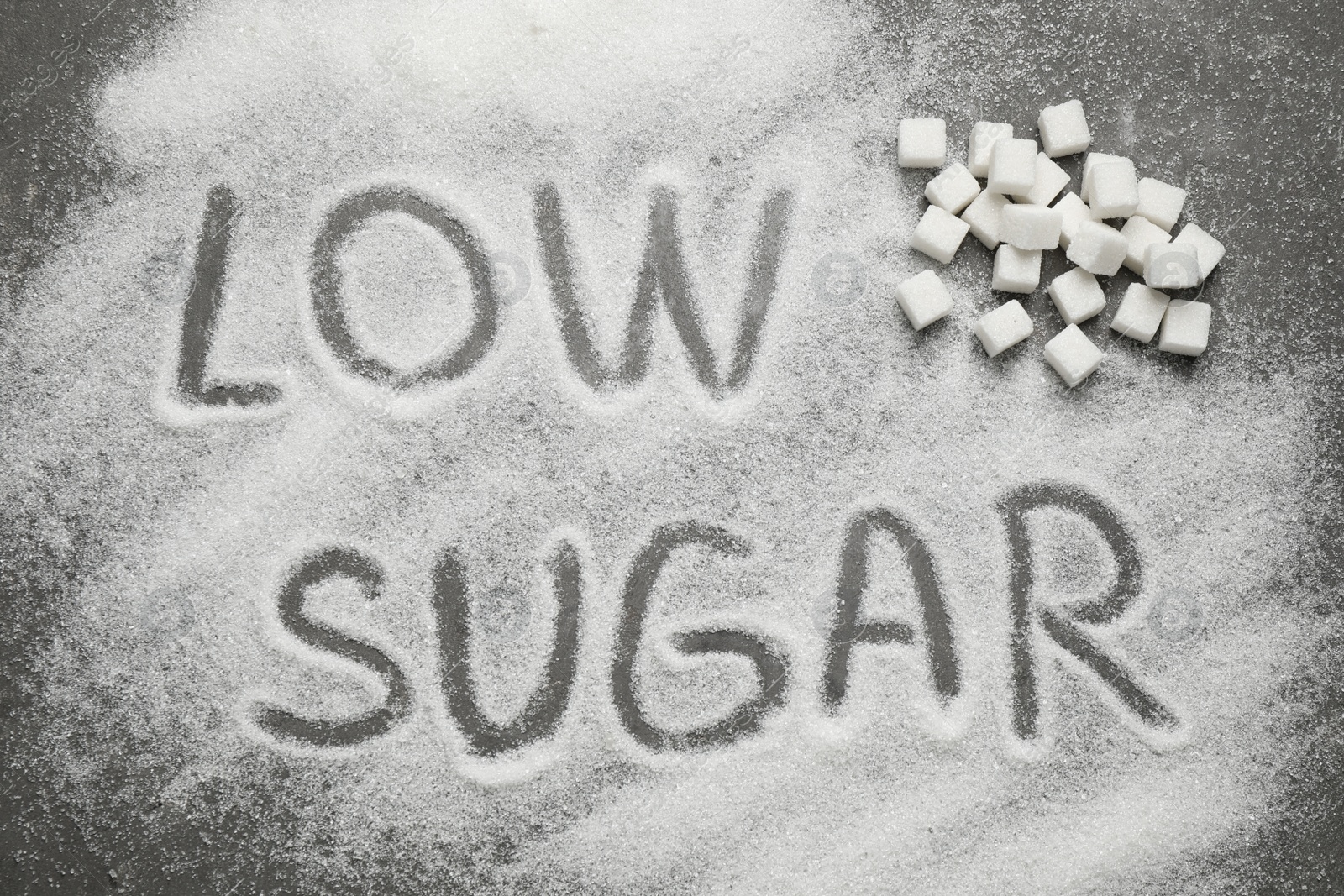 Photo of Flat lay composition with phrase LOW SUGAR on grey table