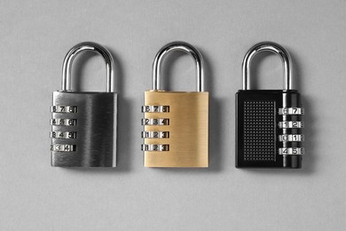 Photo of Steel combination padlocks on grey background, top view