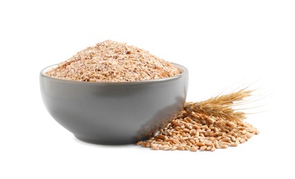 Bowl of wheat bran on white background