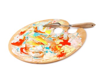 Photo of Dirty wooden artist's palette with painting knife isolated on white