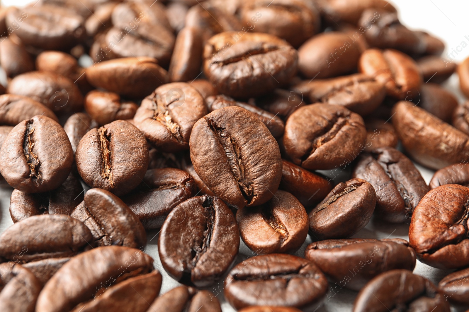 Photo of Pile of roasted coffee beans as background, closeup