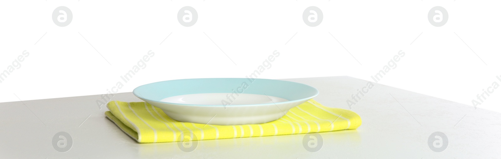 Photo of Empty plate and napkin on light table