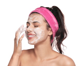 Beautiful woman applying facial cleansing foam on white background