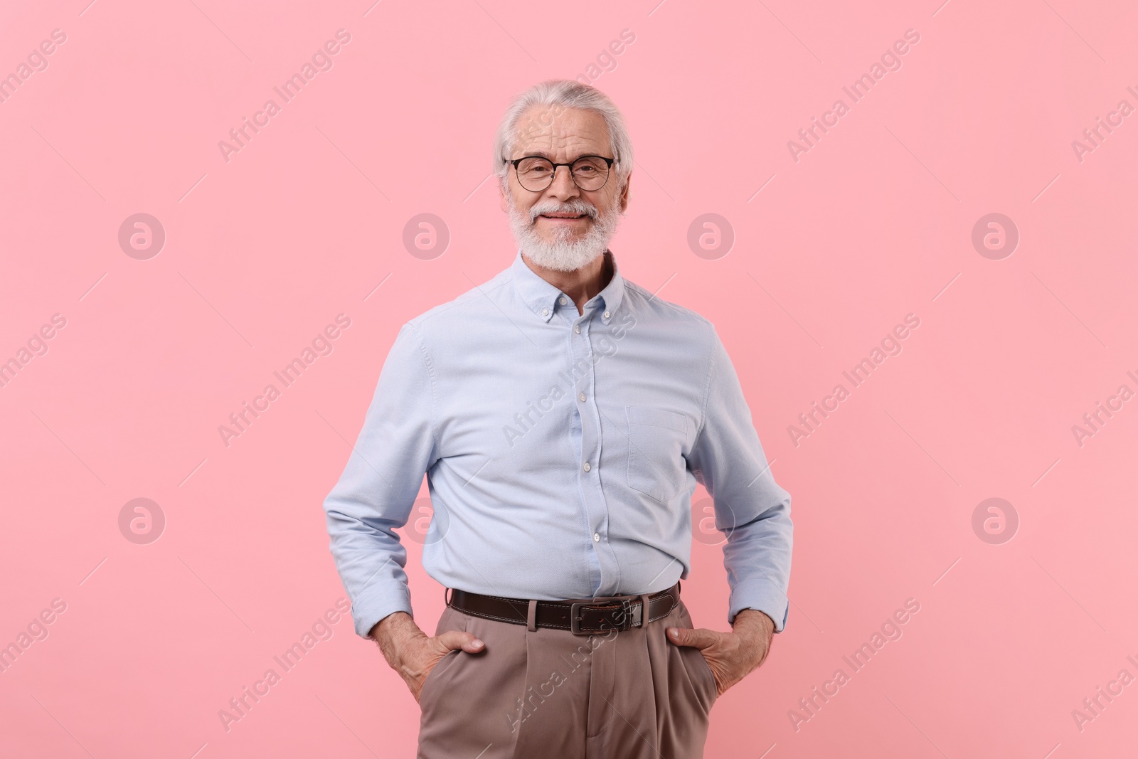Photo of Portrait of stylish grandpa with glasses on pink background