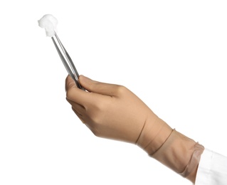 Photo of Doctor in sterile glove holding medical forceps with cotton ball on white background
