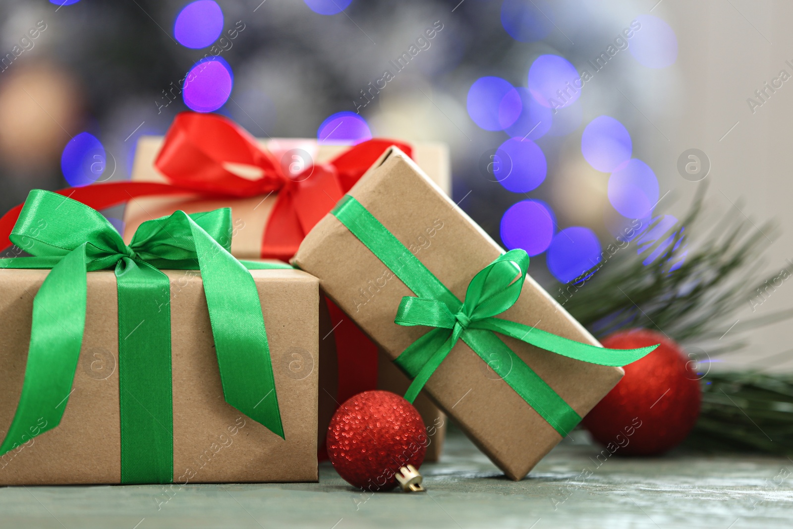 Photo of Christmas gifts on table against blurred background